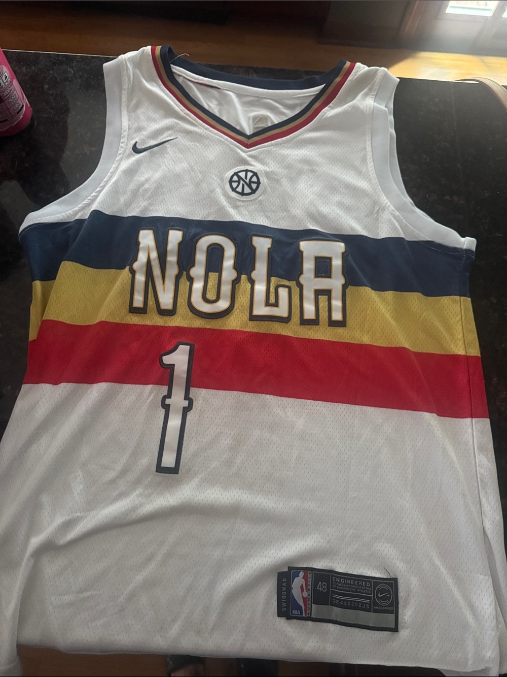 Nike White NOLA Basketball Jersey with Navy, Gold & Red Stripes